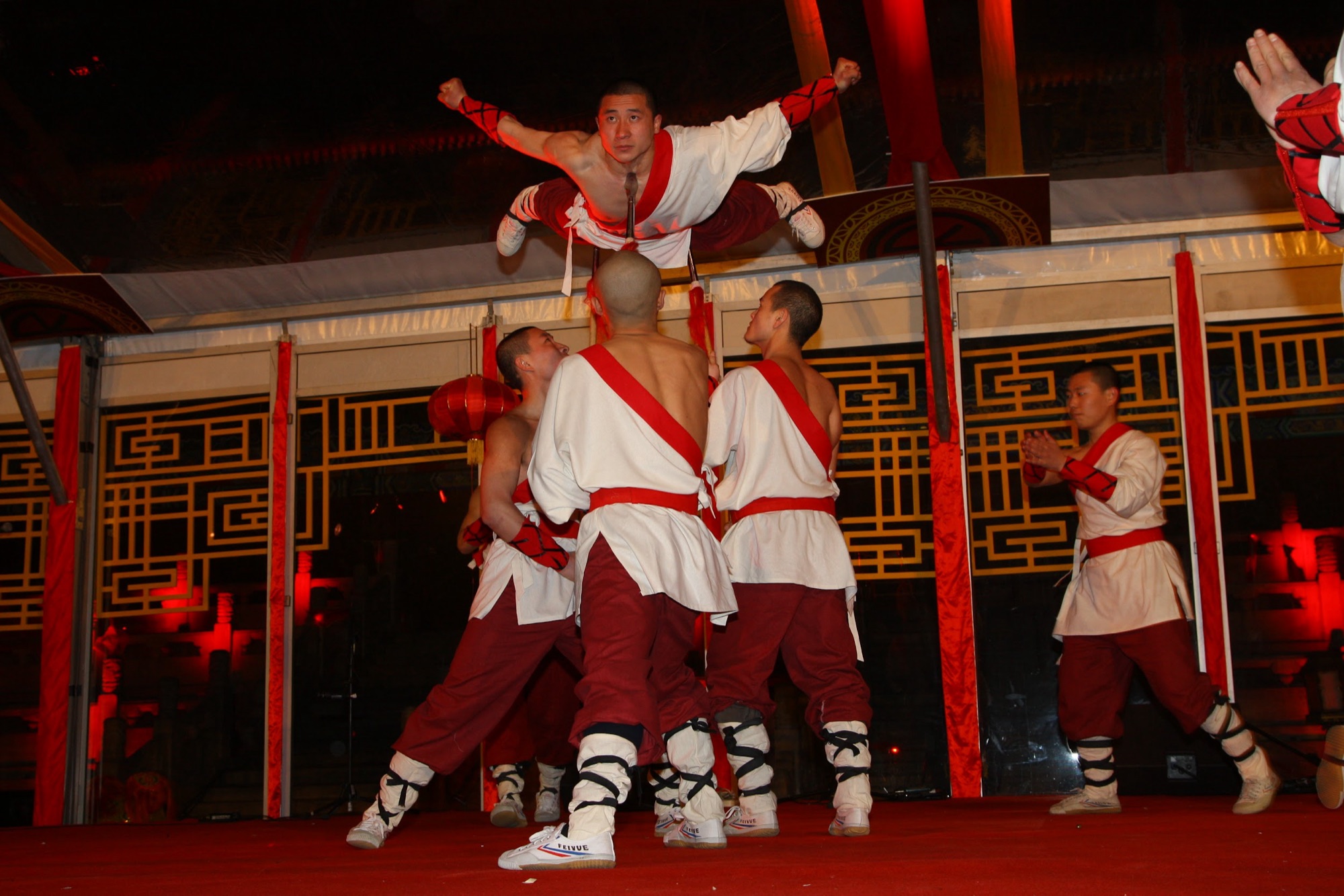 Kung fu performers in mid-flight on stage