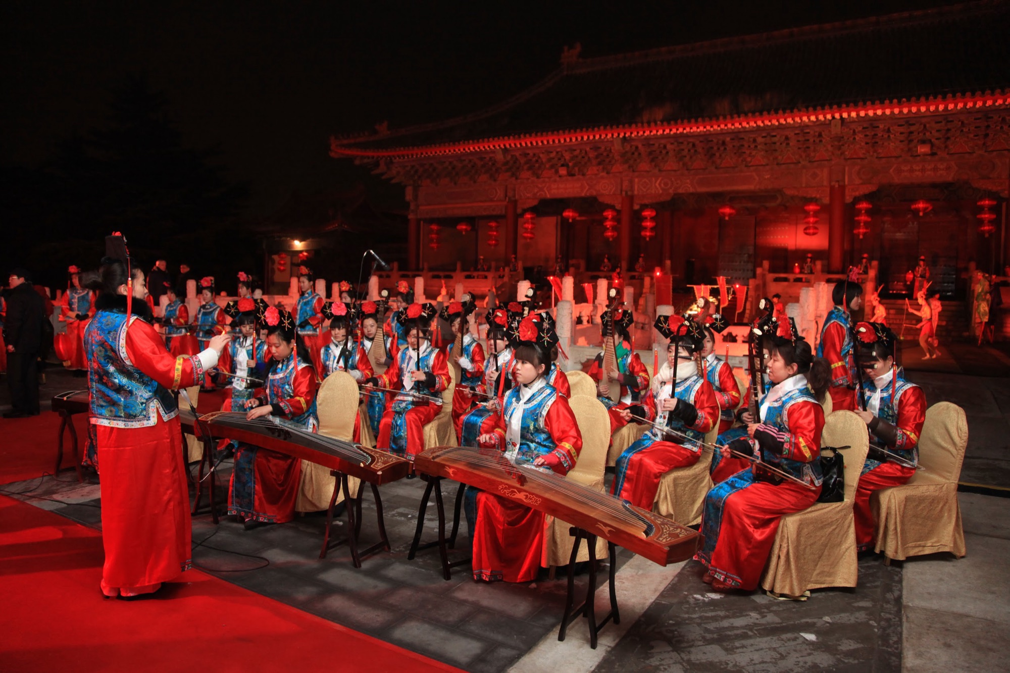Musicians in palace dress playing traditional instruments in the courtyard