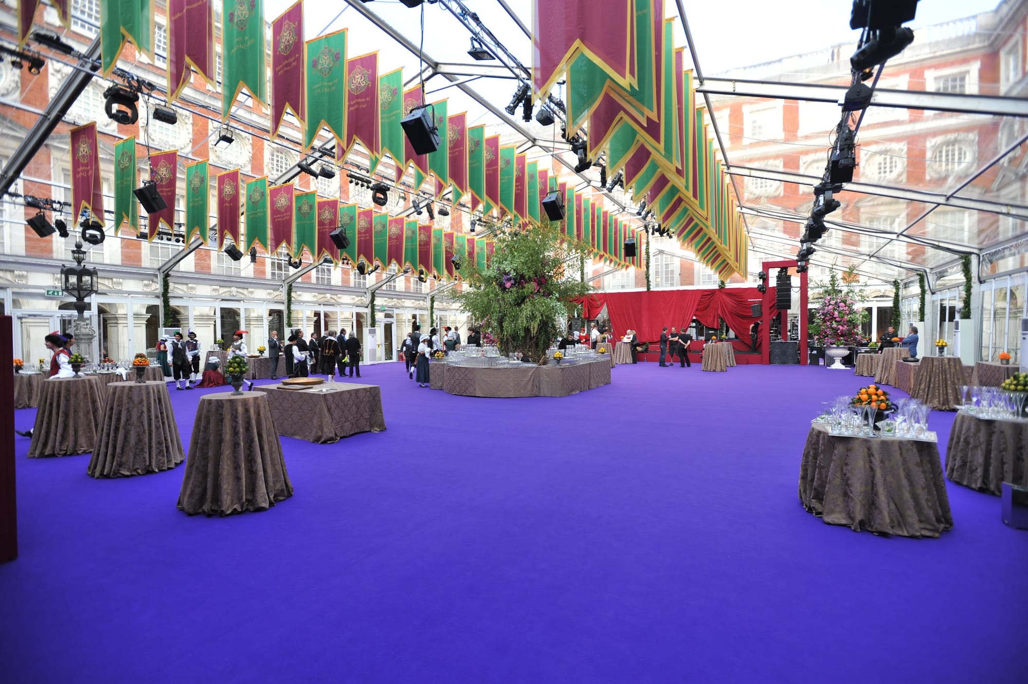 The glass tent dressed with a purple carpet and banners