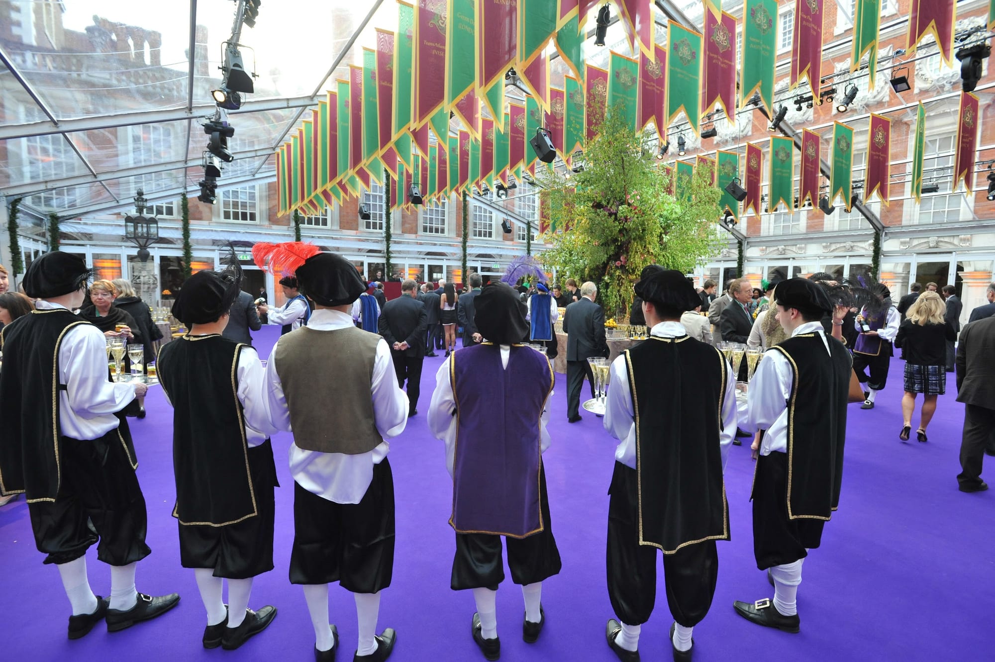Performers in Tudor costume greeting guests in the glass tent