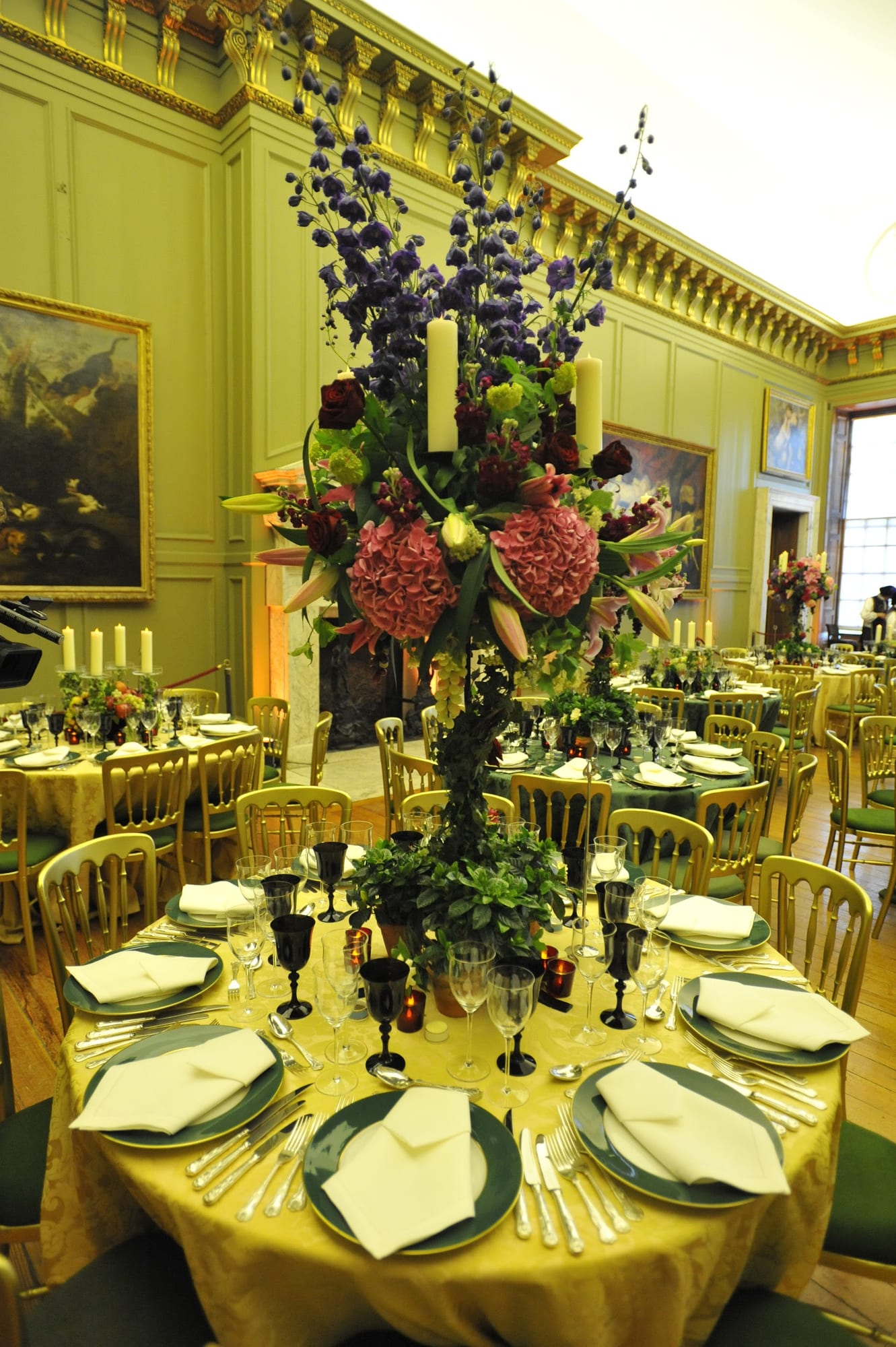 A table set with dark florals in a panelled room