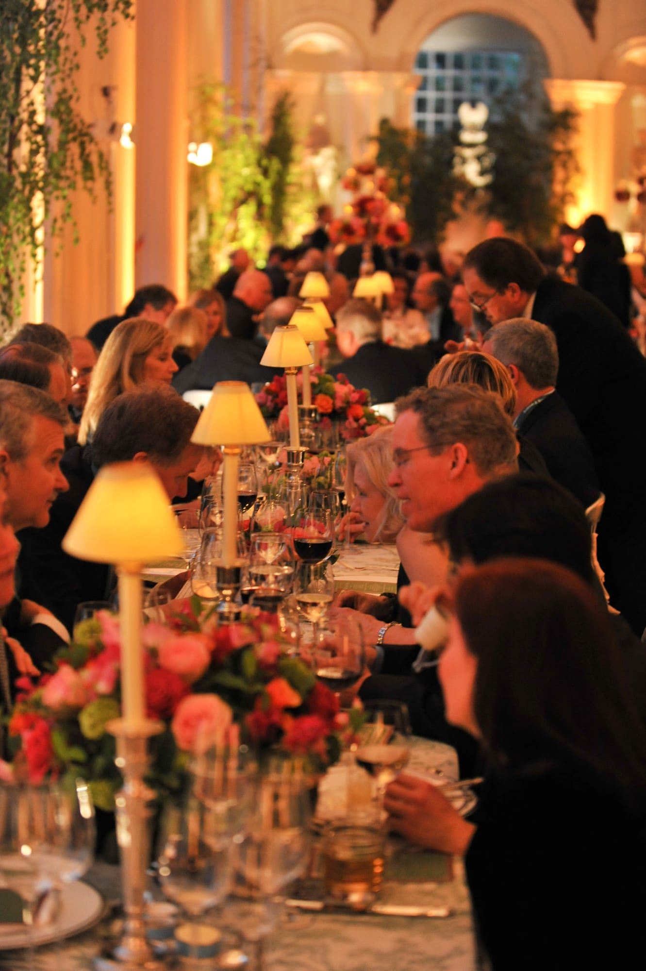 Guests dining by lamplight