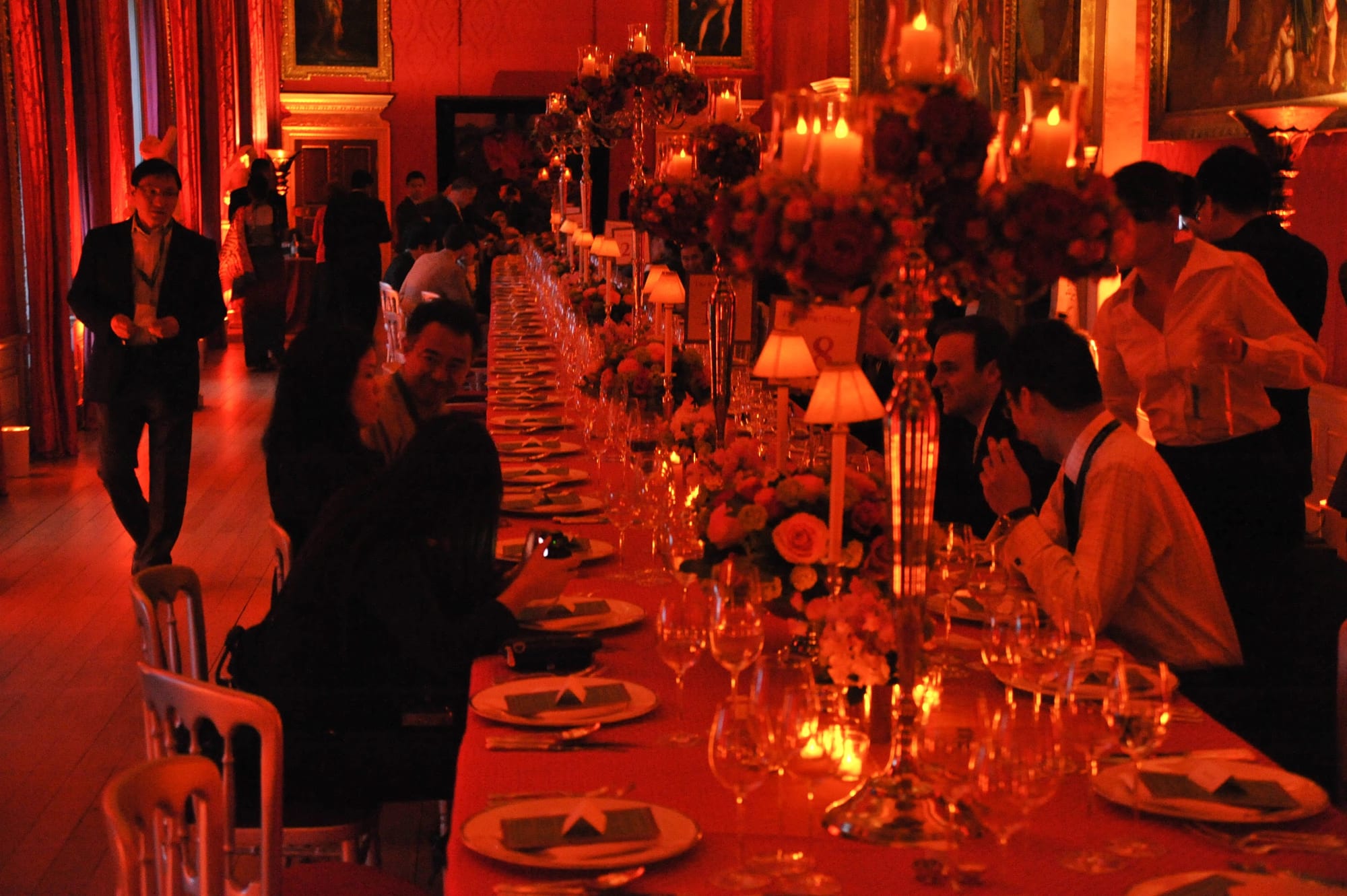 Guests at a long candlelit dinner table