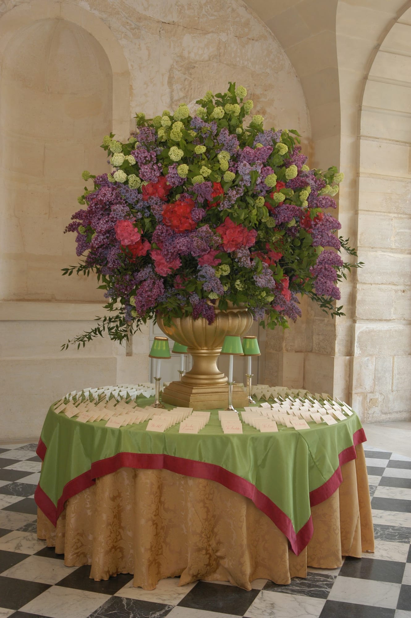 A floral arrangement on a gilded urn inside the palace